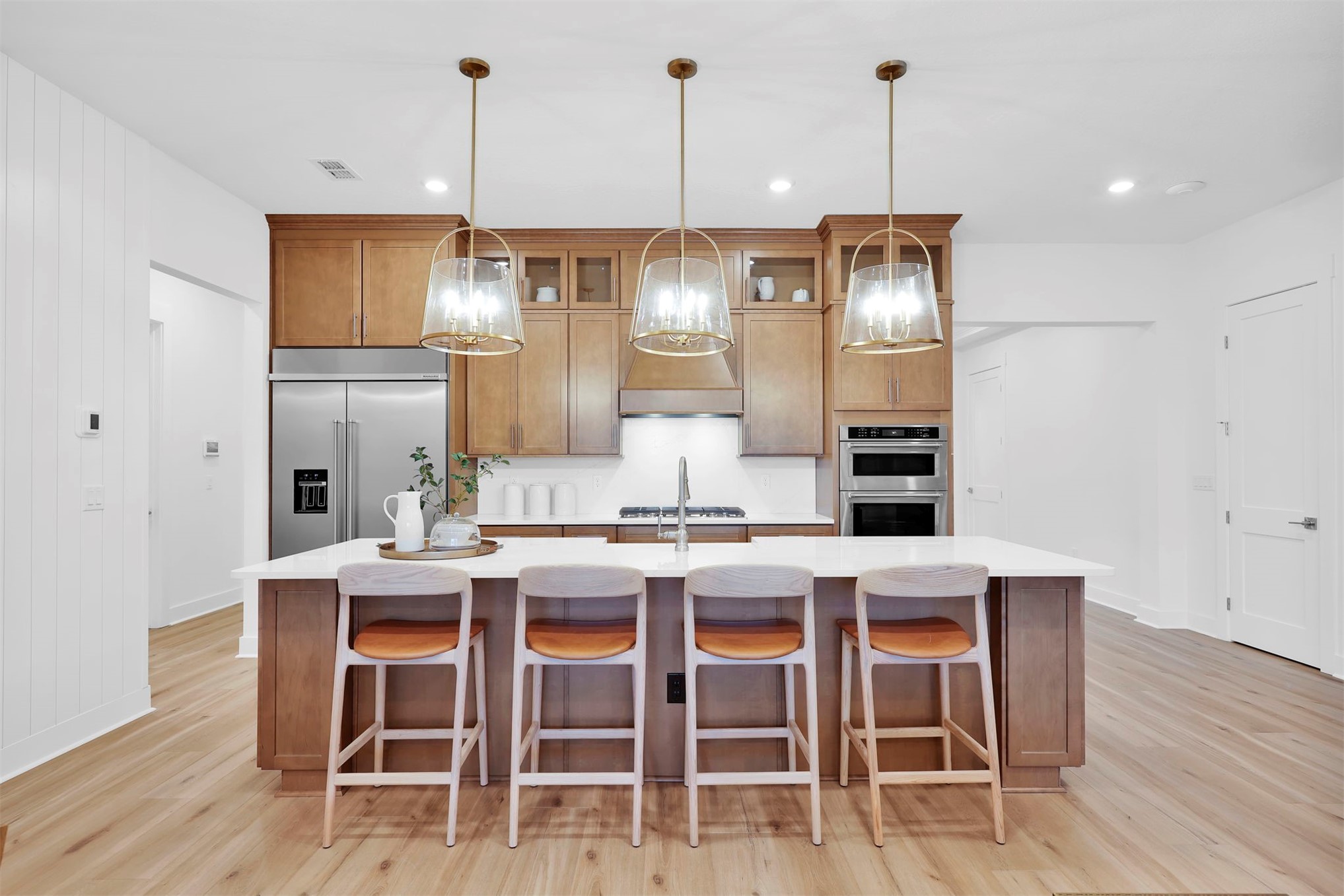 475 Pine Lilly Loop Yulee, FL 32097 - Photo 11 of 24 a kitchen with granite countertop a dining table chairs wooden floor cabinets and stainless steel appliances