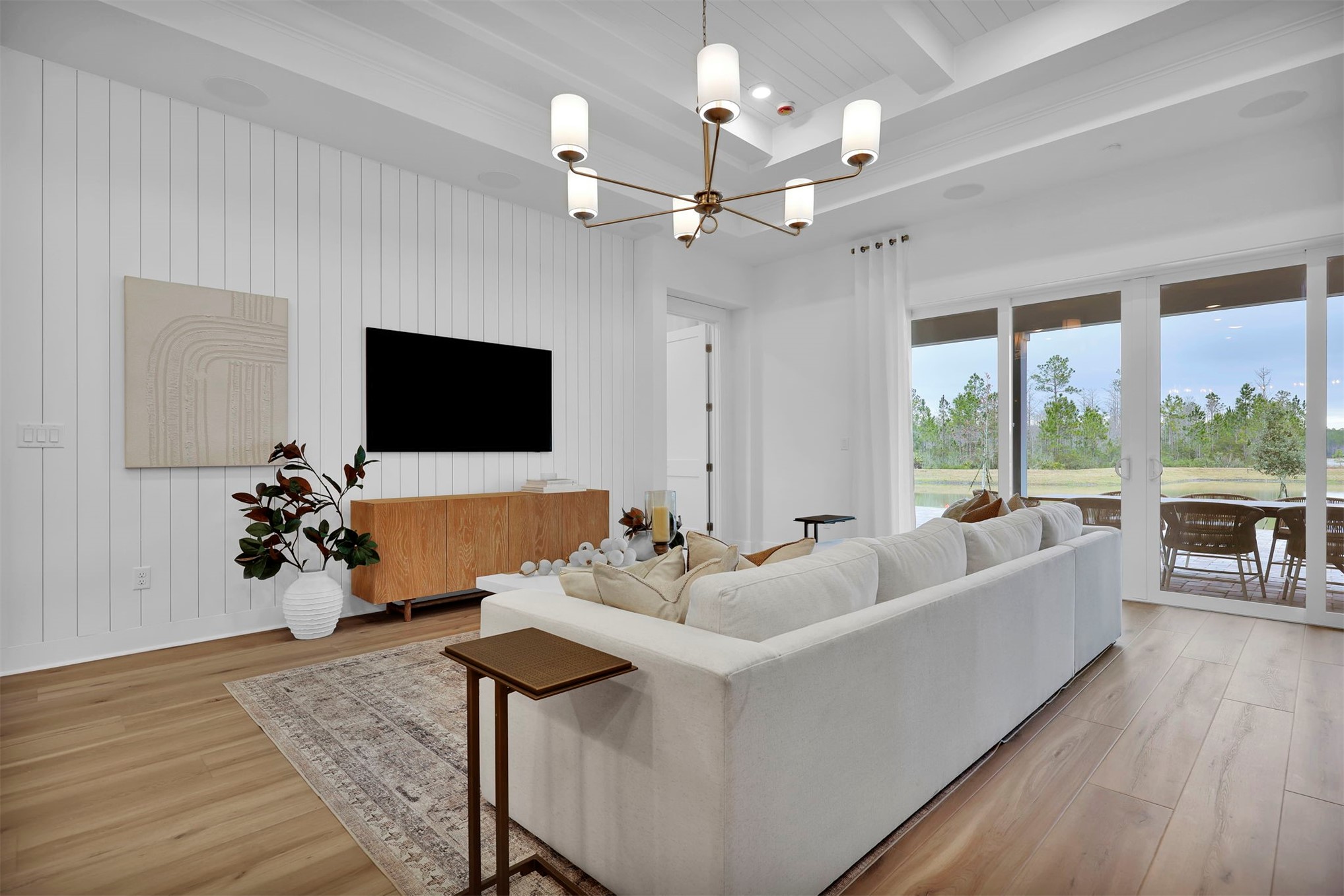 475 Pine Lilly Loop Yulee, FL 32097 - Photo 14 of 24 a living room with furniture chandelier and a flat screen tv