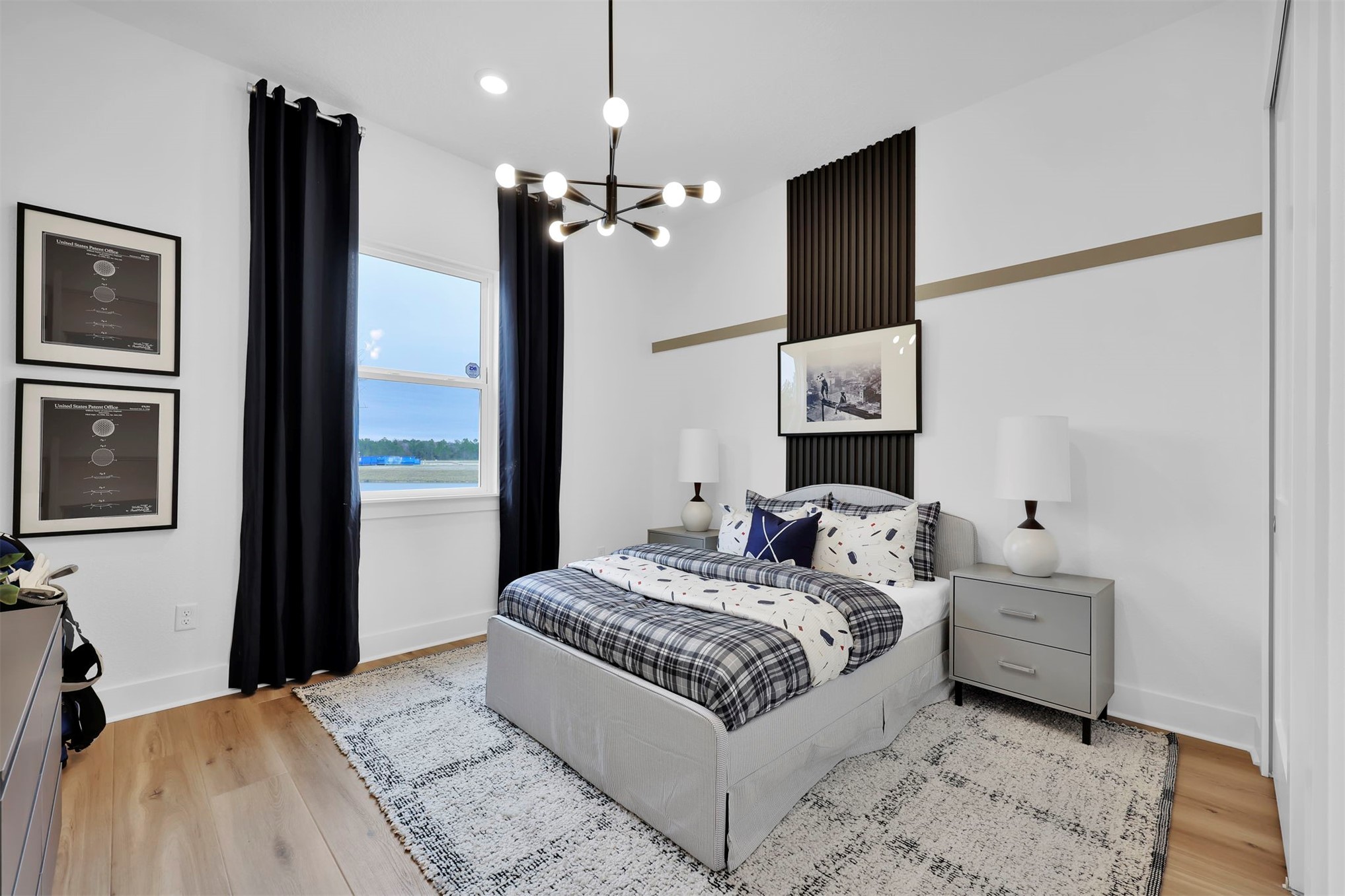 475 Pine Lilly Loop Yulee, FL 32097 - Photo 20 of 24 a bedroom with a large bed and a chandelier