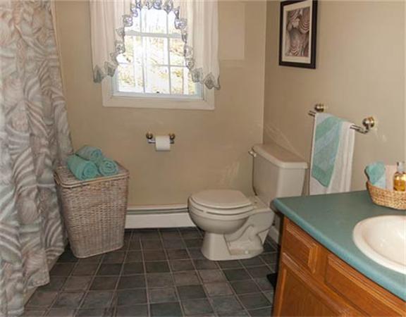 58 Allen Road Sturbridge, MA 01566 - Photo 14 of 18 a bathroom with a granite countertop toilet and a sink