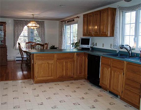 58 Allen Road Sturbridge, MA 01566 - Photo 5 of 18 a kitchen with granite countertop a sink stainless steel appliances wooden floor and cabinets