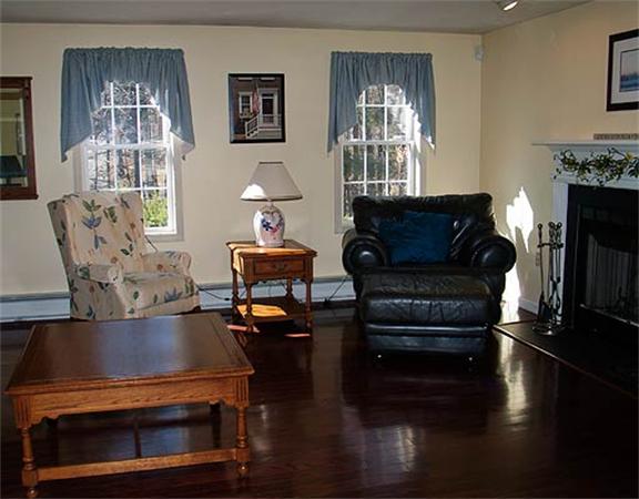 58 Allen Road Sturbridge, MA 01566 - Photo 8 of 18 a living room with furniture fireplace and a window
