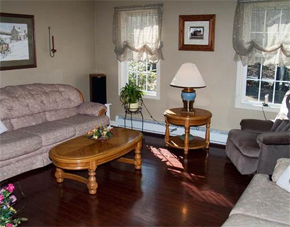 58 Allen Road Sturbridge, MA 01566 - Photo 9 of 18 a living room with furniture a lamp and a large window