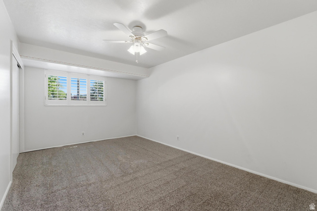 148 Tennyson Avenue Sandy, UT 84070 - Photo 26 of 55 Carpeted room featuring a white ceiling fan with integrated lighting, a window with white plantation shutters, and a sliding door closet