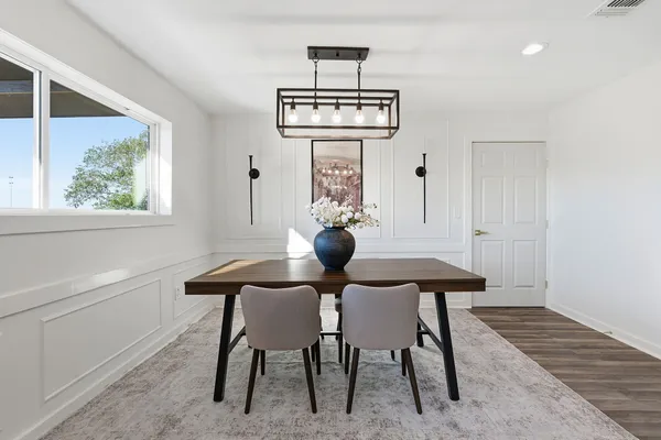 a view of a dining room with furniture and chandelier