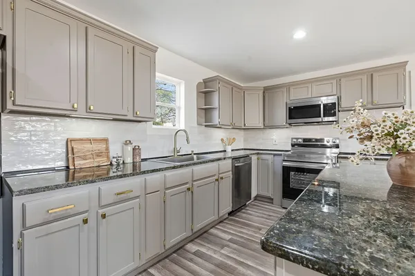 a kitchen with a sink stove and cabinets