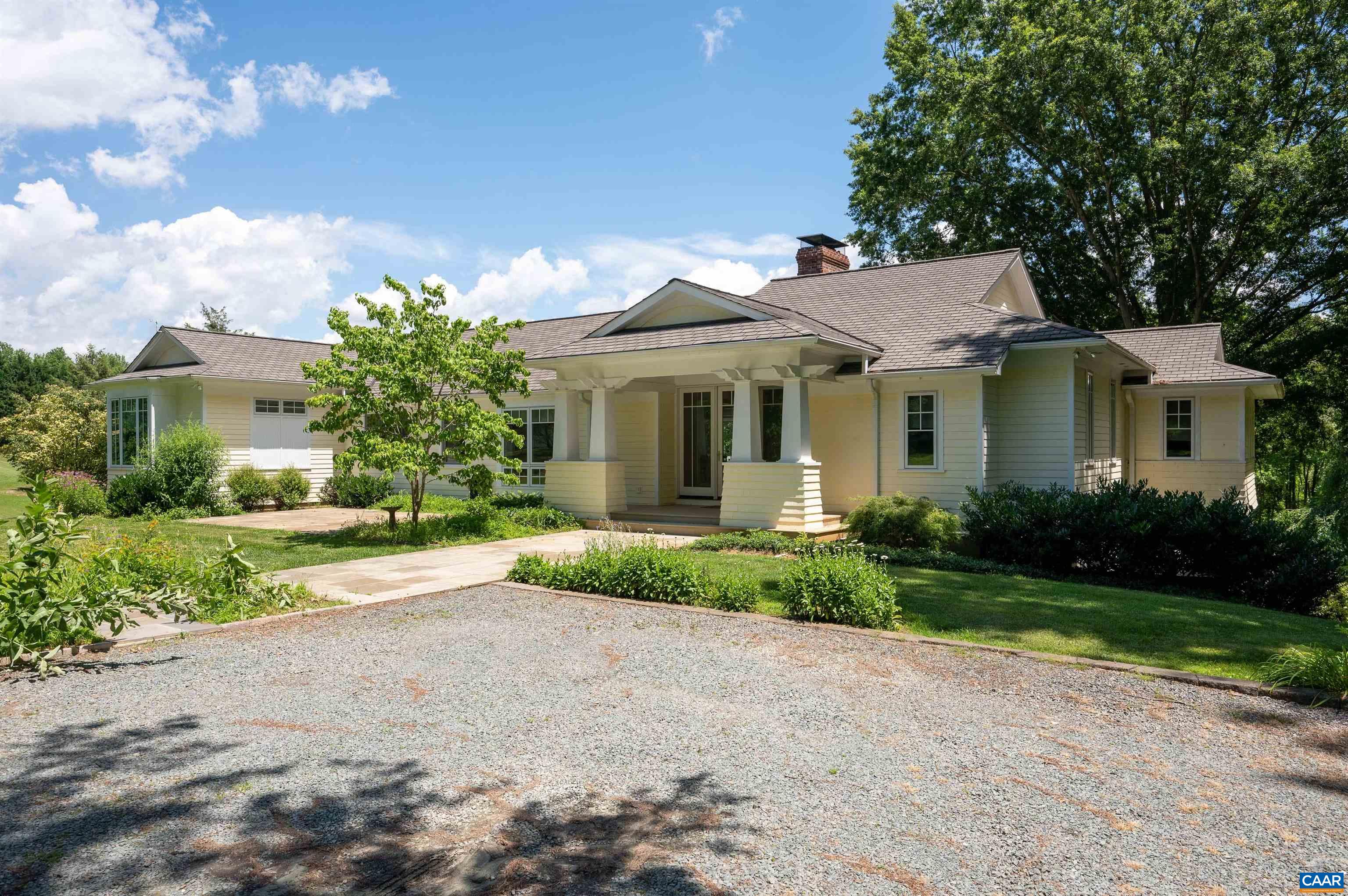 a front view of a house with a yard and outdoor seating