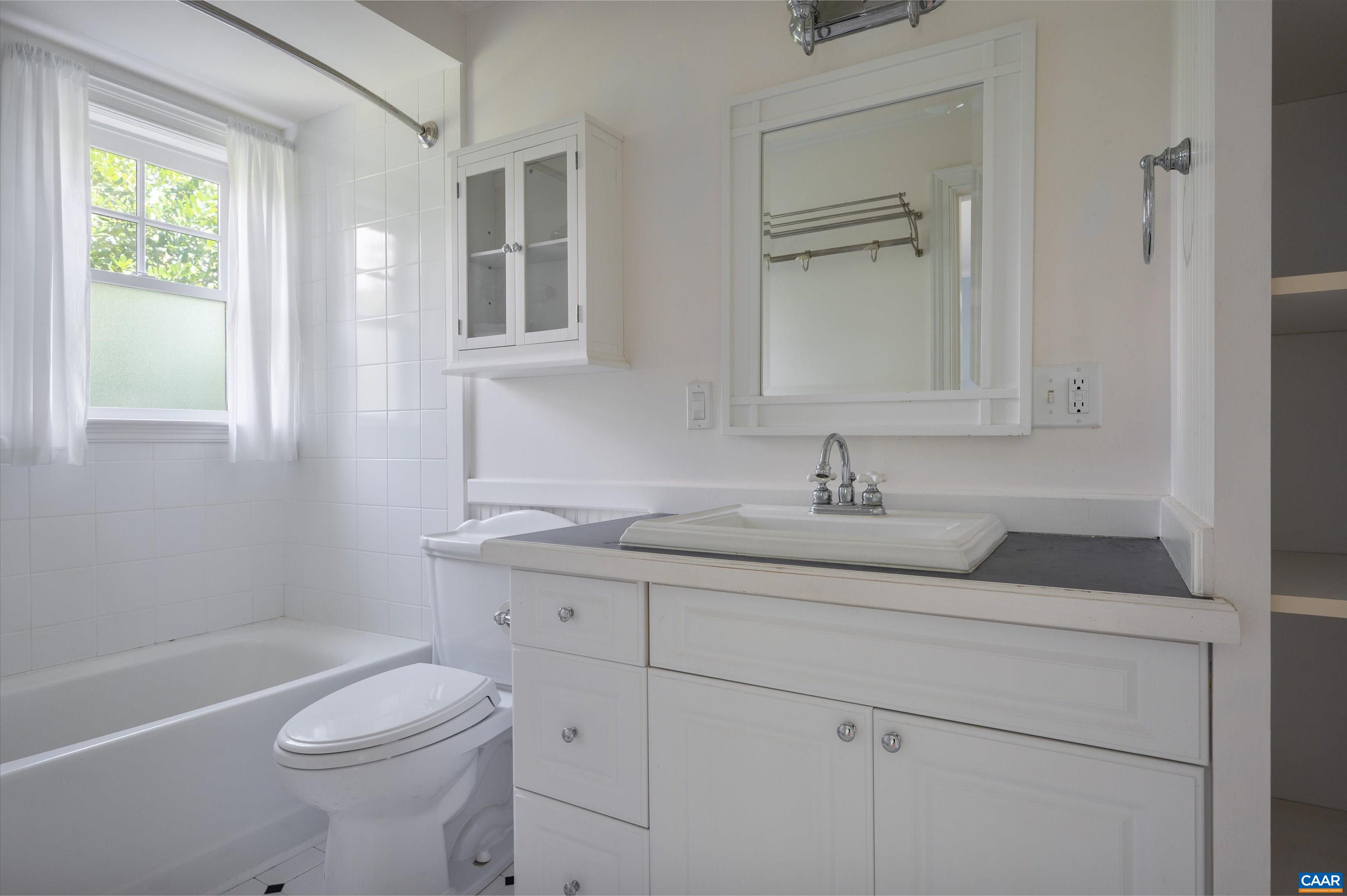 2845 Earlysville Road Earlysville, VA 22936 - Photo 13 of 35 a bathroom with a granite countertop toilet a sink a mirror and a bathtub