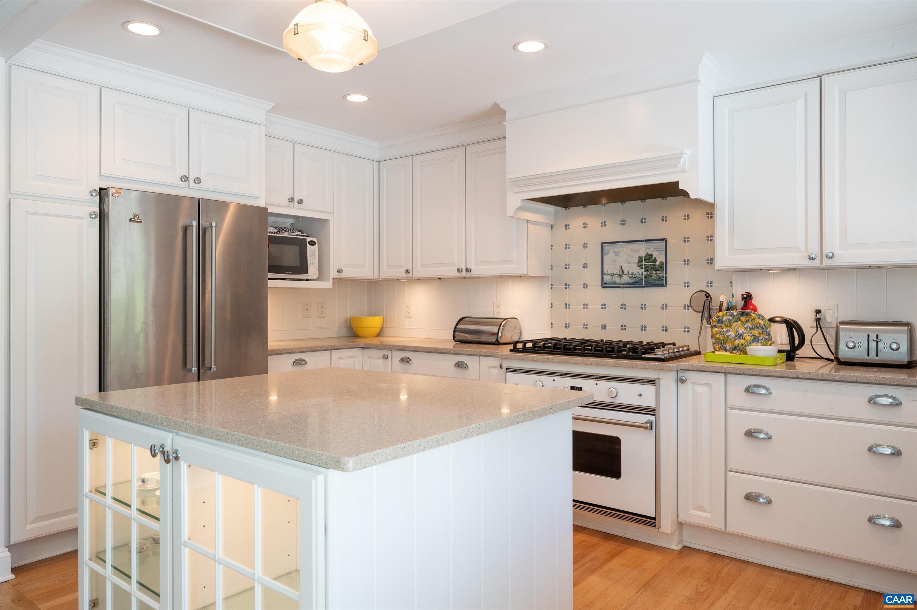 2845 Earlysville Road Earlysville, VA 22936 - Photo 7 of 35 a kitchen with granite countertop a refrigerator a stove a sink and white cabinets