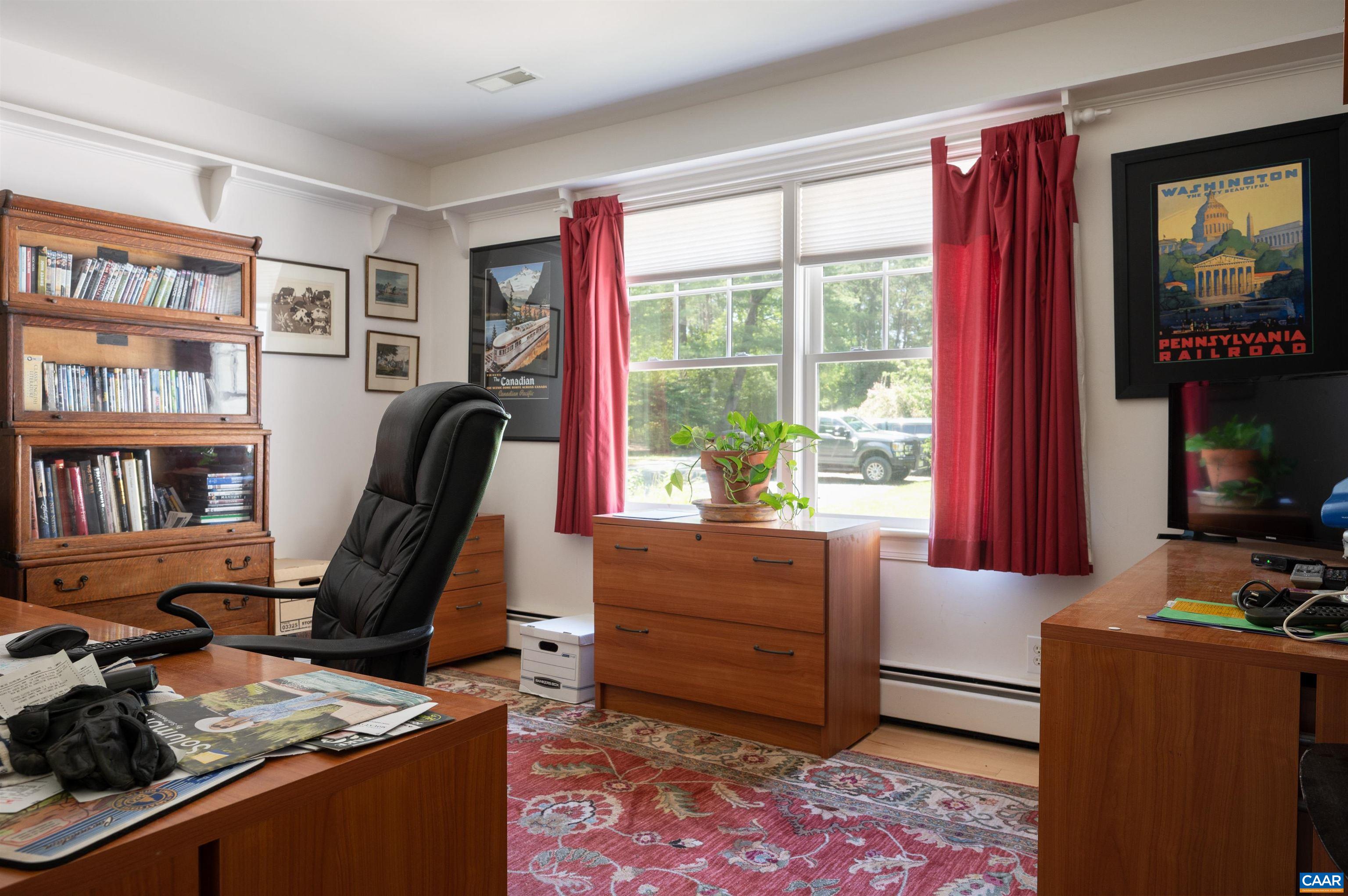 2845 Earlysville Road Earlysville, VA 22936 - Photo 10 of 35 a view of a workspace with furniture and a bookshelf