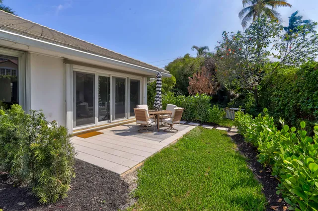 a view of a backyard with sitting area and garden