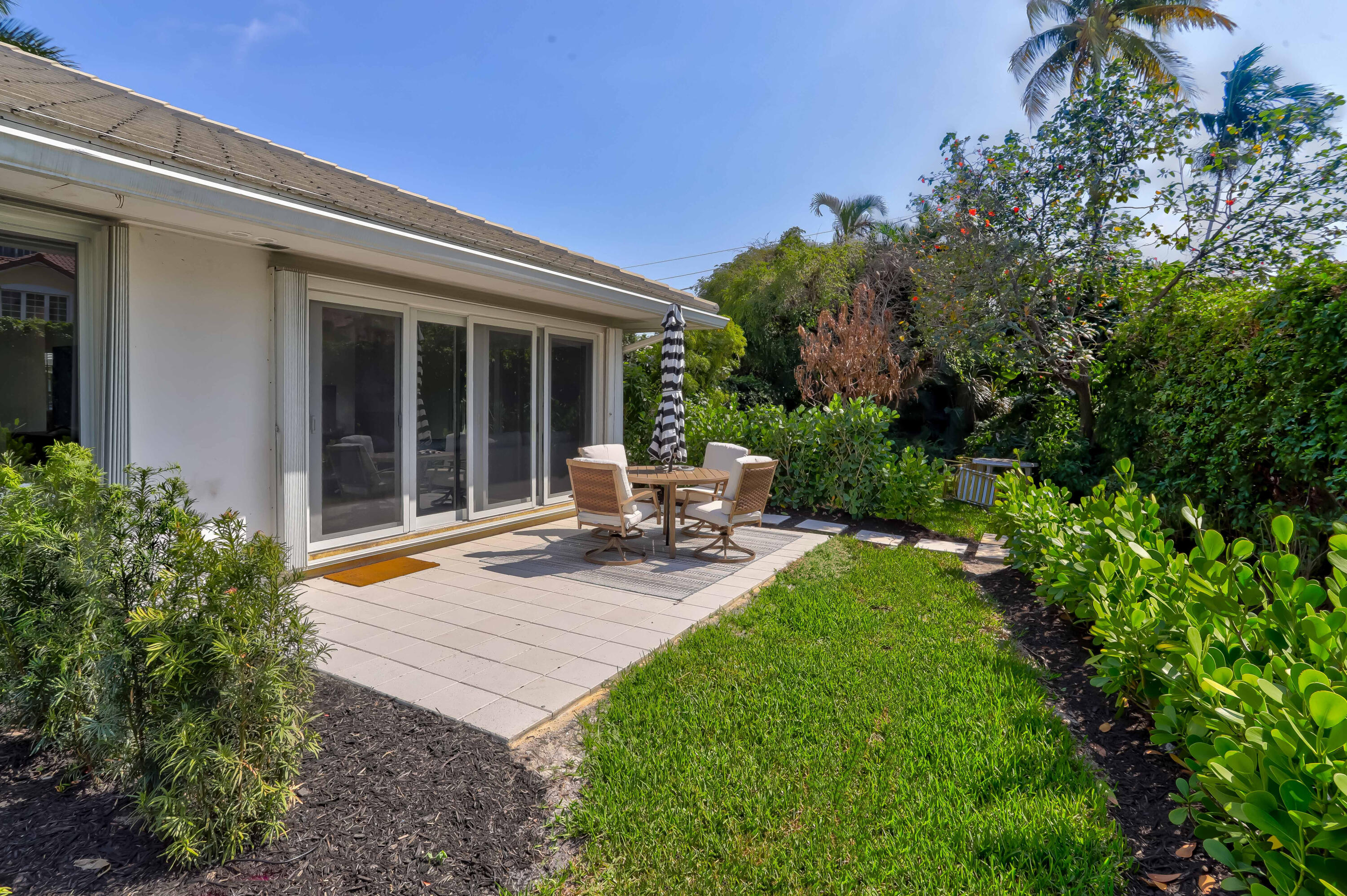 1004 Langer Way Delray Beach, FL 33483 - Photo 18 of 19 a view of a backyard with sitting area and garden