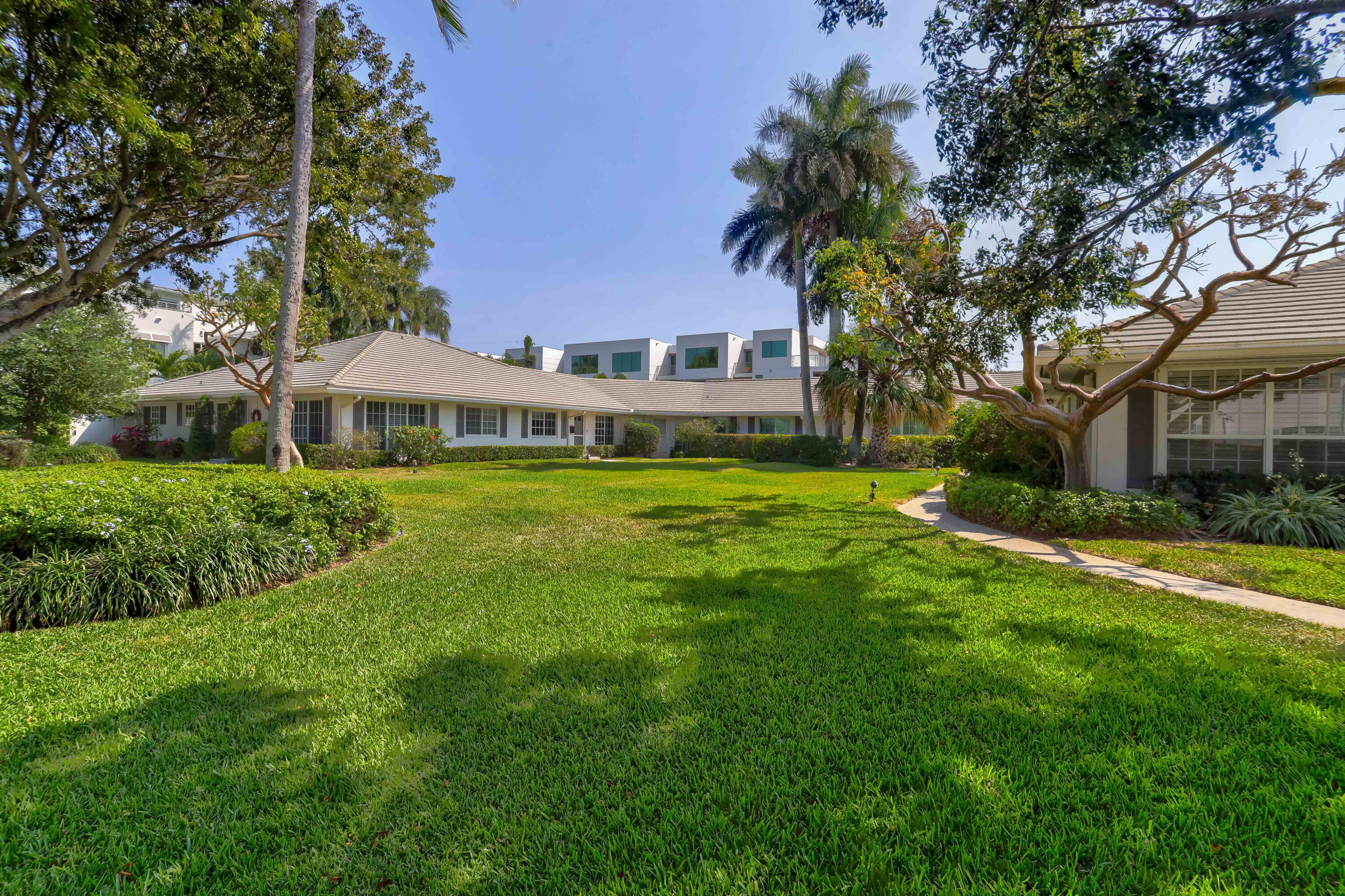 1004 Langer Way Delray Beach, FL 33483 - Photo 2 of 19 a view of a house with a big yard and large trees