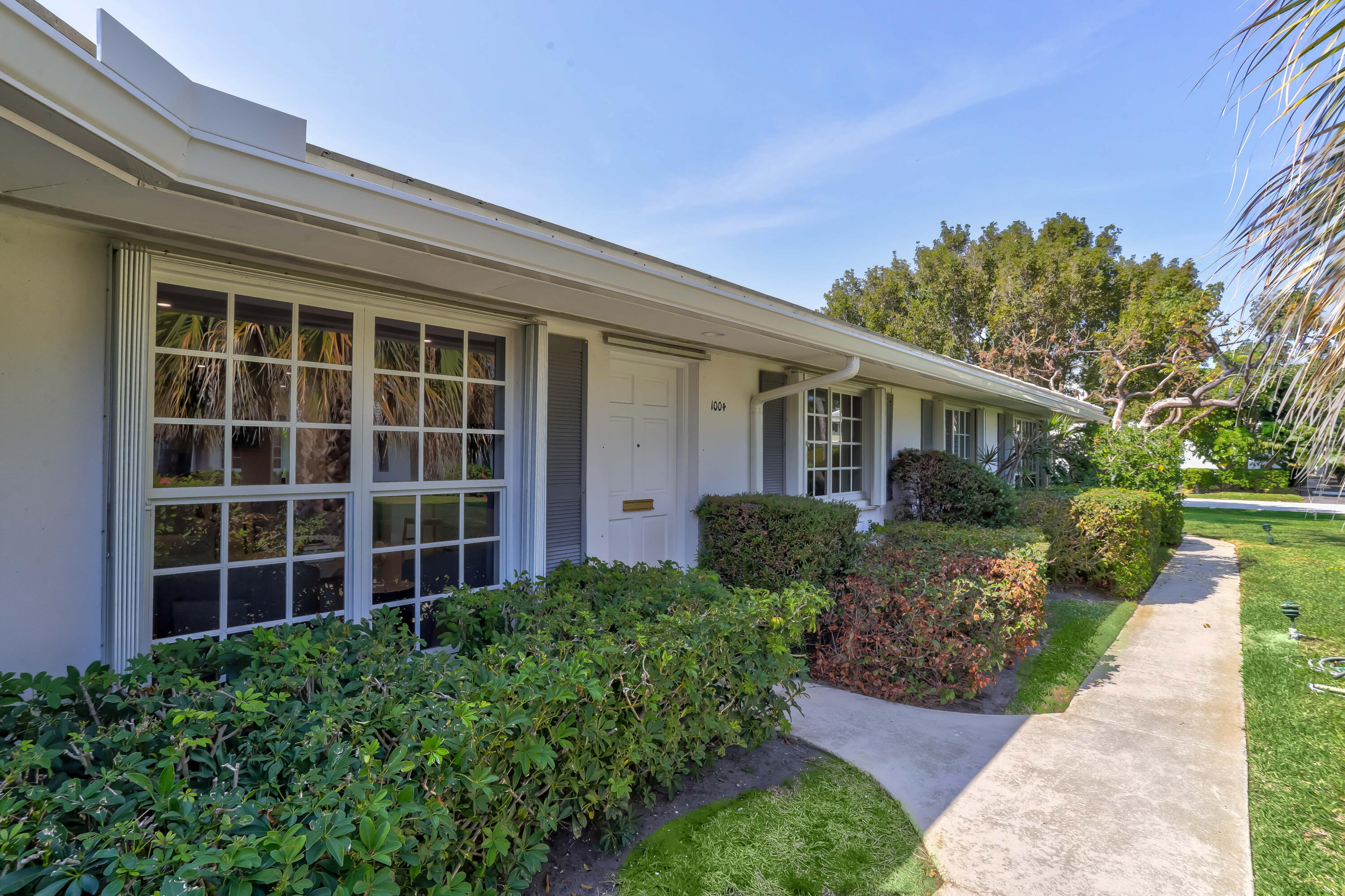 1004 Langer Way Delray Beach, FL 33483 - Photo 3 of 19 front view of a house with a yard