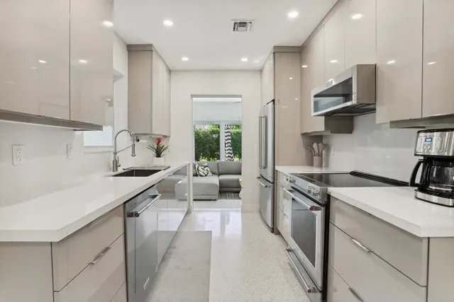 a kitchen with a sink stainless steel appliances and cabinets
