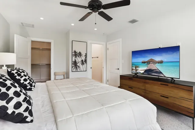 a bedroom with a bed and a chandelier