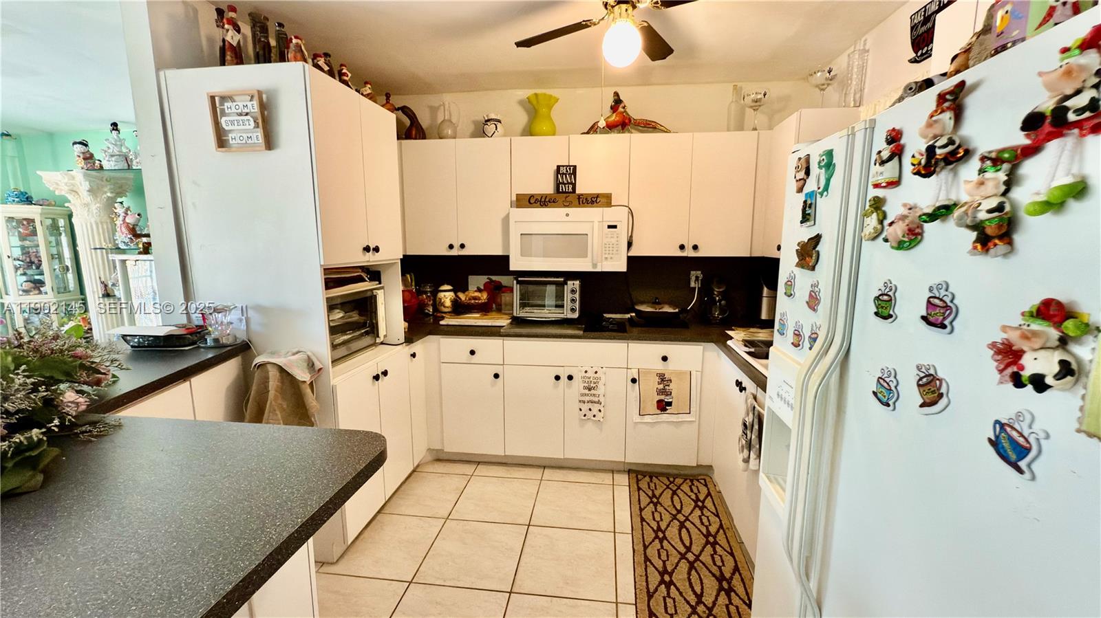 3861 Northwest 177th Street Miami Gardens, FL 33055 - Photo 11 of 15 a kitchen with stainless steel appliances a stove a refrigerator and a table