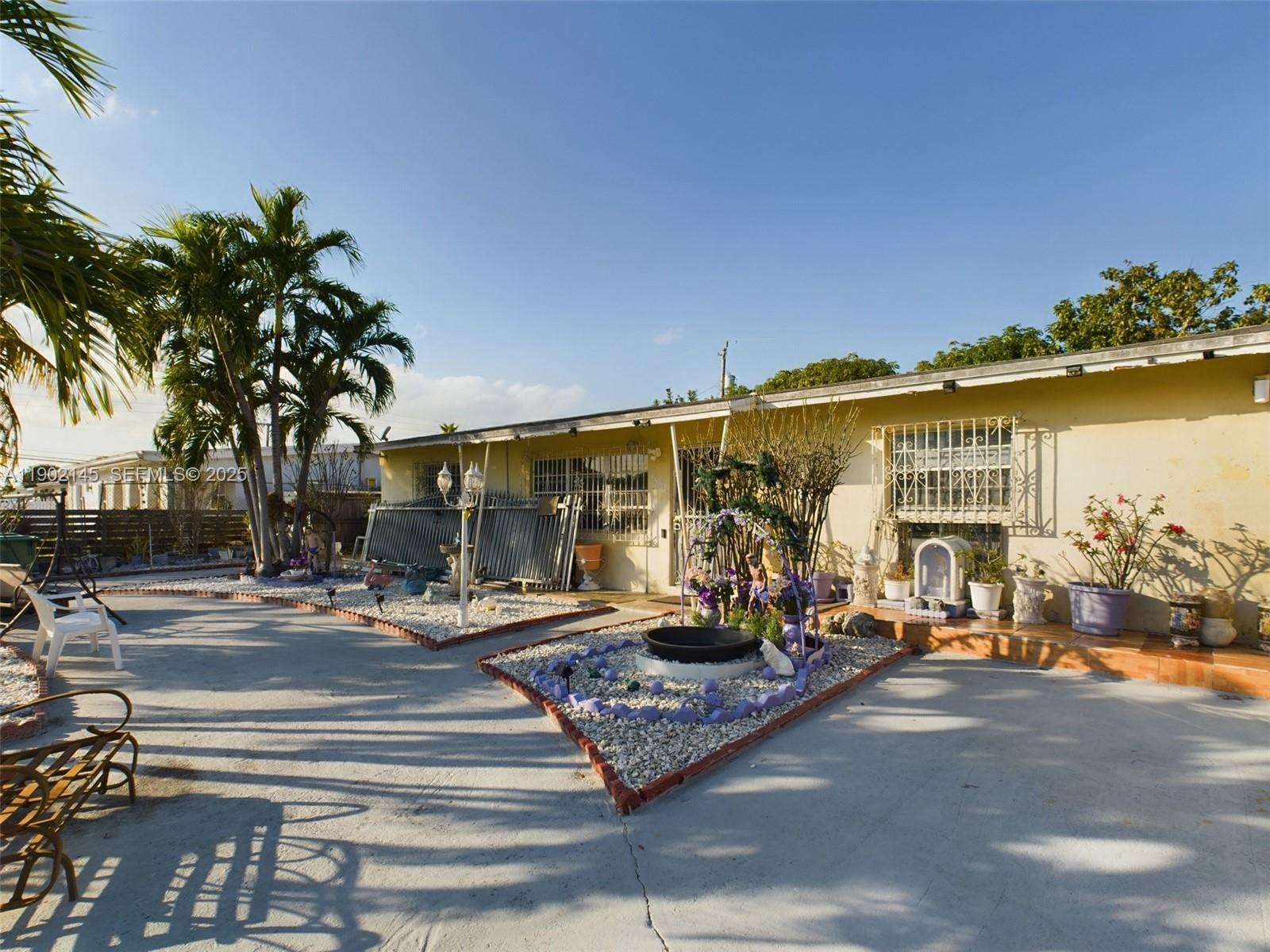 3861 Northwest 177th Street Miami Gardens, FL 33055 - Photo 3 of 15 a outdoor space with lots of palm trees