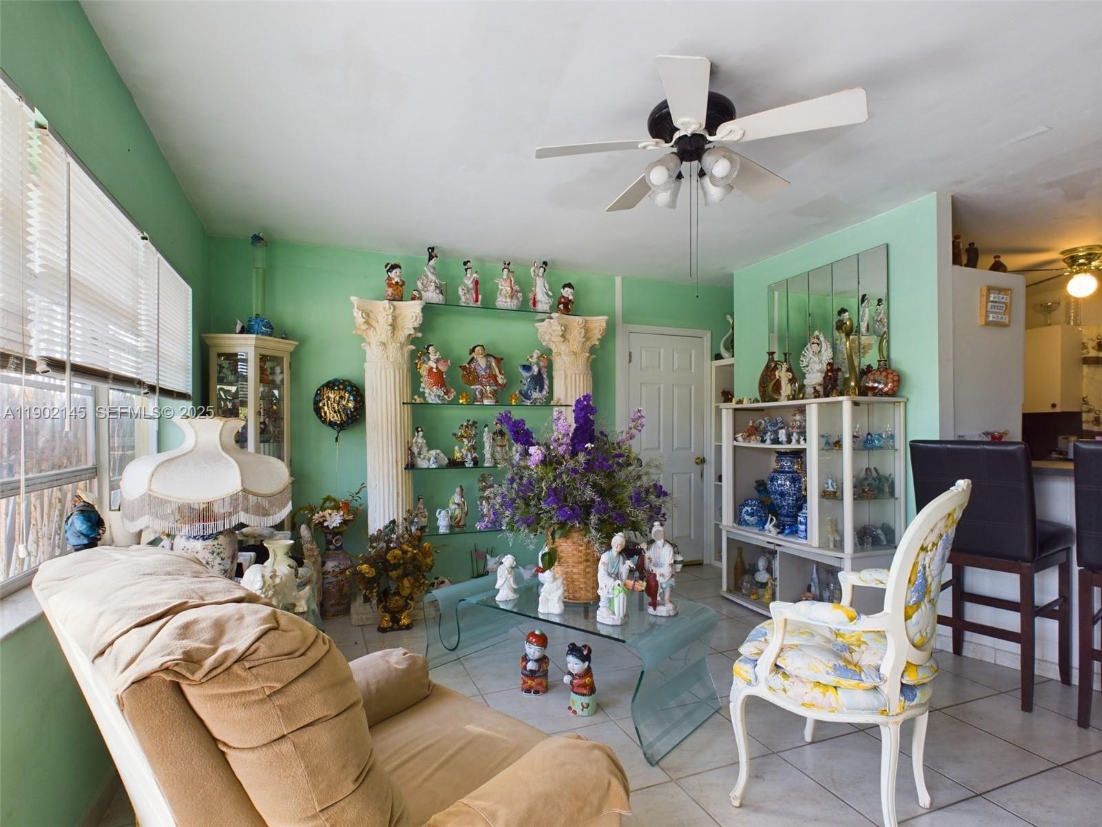 3861 Northwest 177th Street Miami Gardens, FL 33055 - Photo 7 of 15 a view of a livingroom with furniture and a ceiling fan