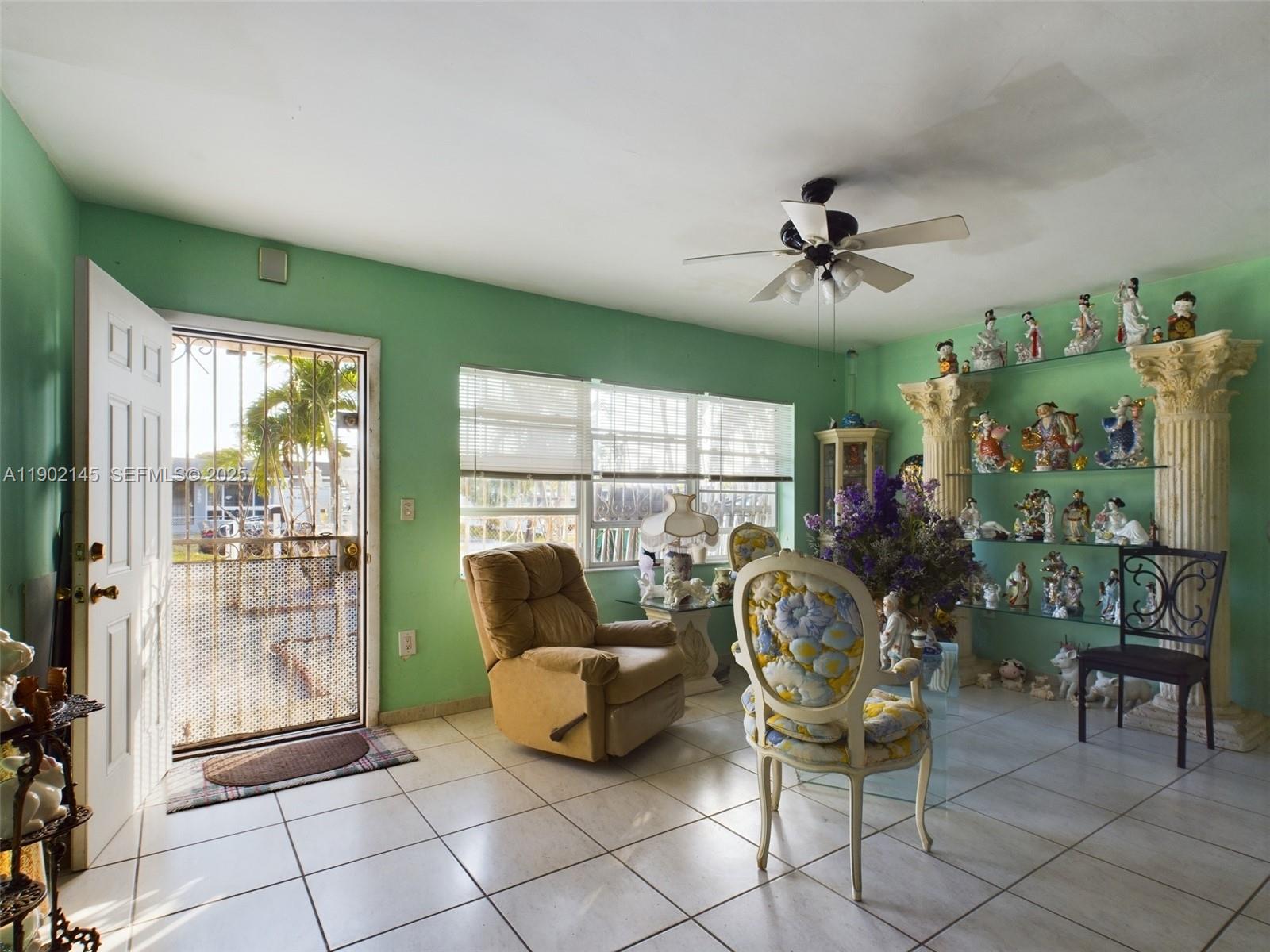 3861 Northwest 177th Street Miami Gardens, FL 33055 - Photo 8 of 15 a living room with furniture and a floor to ceiling window
