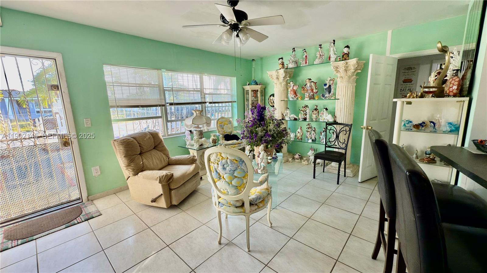 3861 Northwest 177th Street Miami Gardens, FL 33055 - Photo 9 of 15 a living room with furniture and a floor to ceiling window