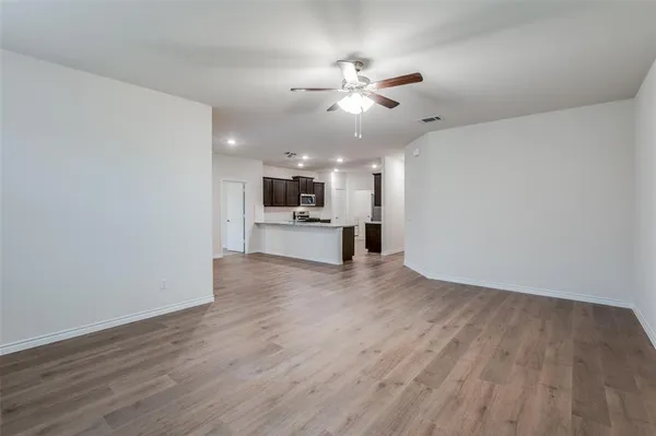 a view of a kitchen with a dishwasher cabinets and wooden floor
