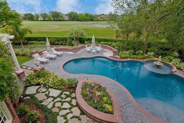 an aerial view of a house with outdoor space and lake view