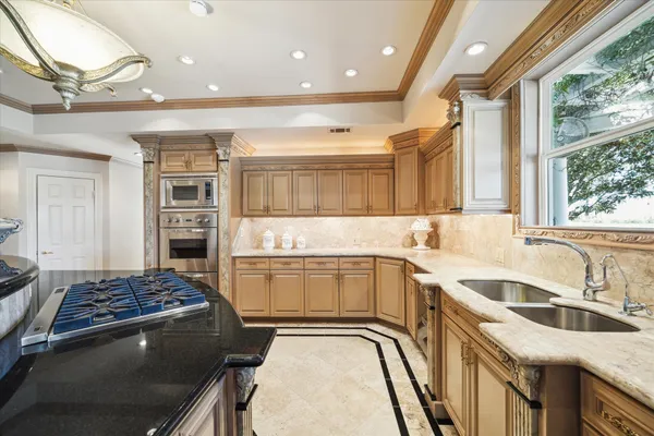 a kitchen with a sink stove and refrigerator