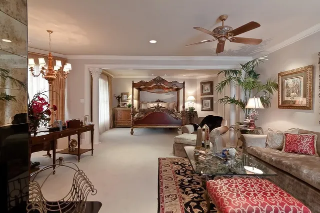 a living room with furniture a chandelier and a flat screen tv
