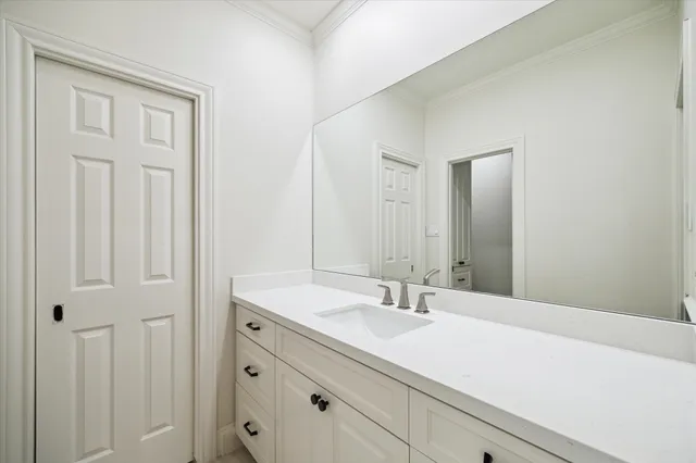 a dinning area with glass top table and chairs