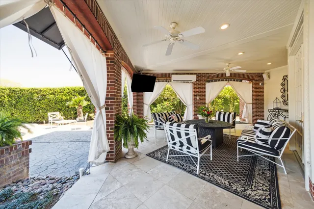 a view of a livingroom with furniture and a floor to ceiling window