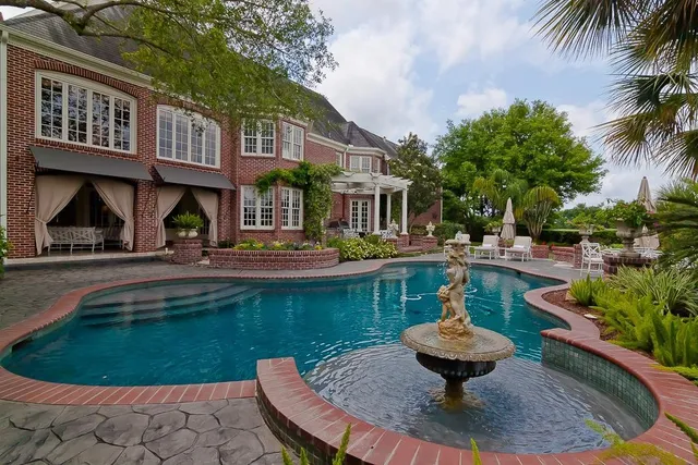 a view of a patio with a table and chairs and potted plants