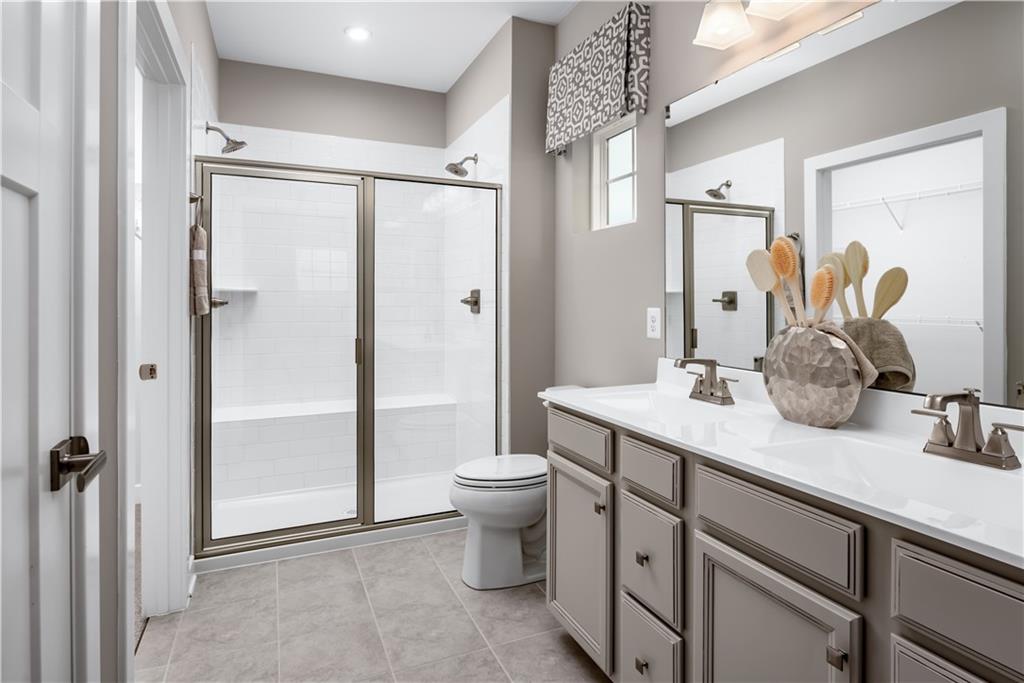 334 Dana Drive Eighty Four, PA 15330 - Photo 8 of 12 a bathroom with a double vanity sink toilet and shower