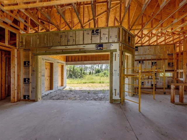 a view of a backyard with large trees and plants