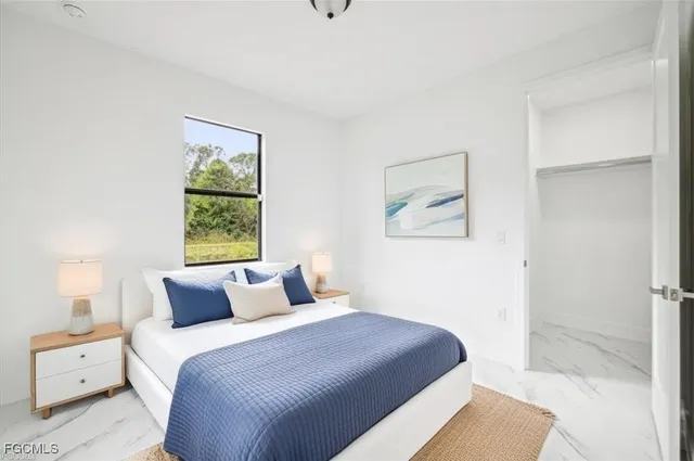 a bedroom with a bed and a painting on the wall