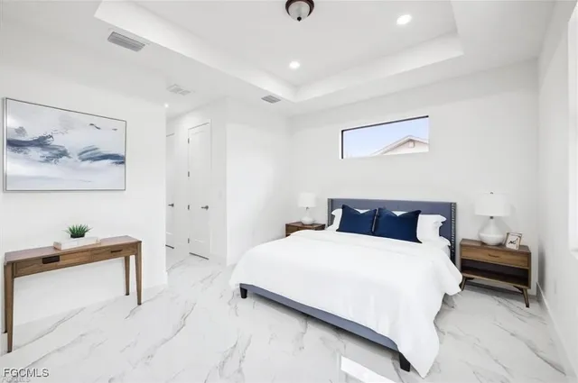 a bedroom with a bed and a lamp