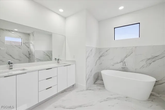 a spacious bathroom with a bathtub and sink