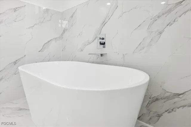 a white bath tub sitting in a bathroom