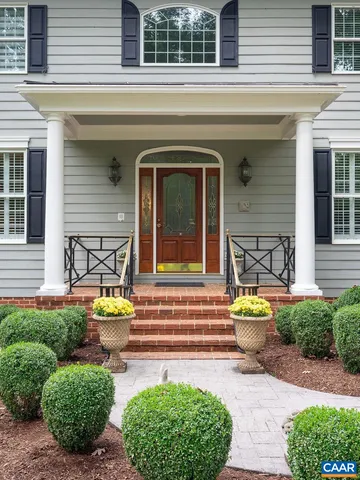 a view of a house with patio and a garden