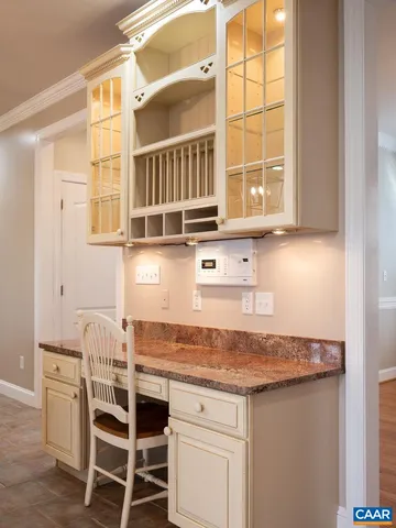 a living room with furniture fireplace and a large window