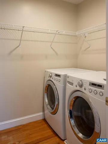 an empty room with windows and ceiling fan