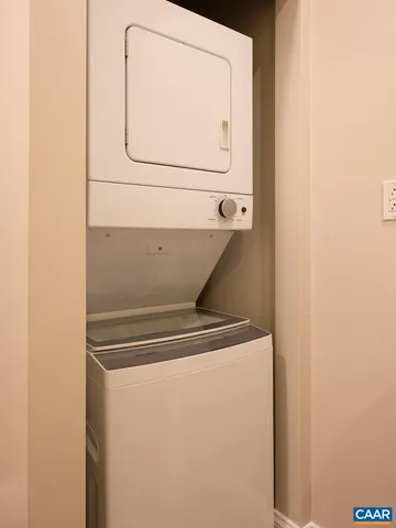 an empty room with fireplace and fan