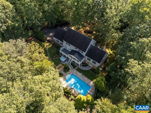 an aerial view of house with yard and tree