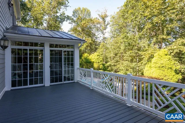 a view of deck with a large window and wooden fence