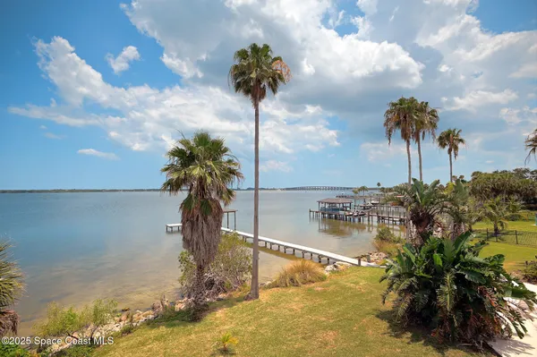 a view of a house with a yard and a garage