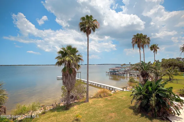a view of a house with a yard and a garage