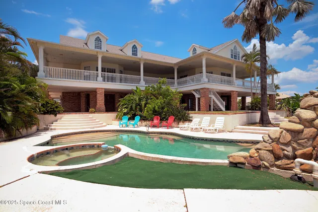 a swimming pool with outdoor seating and yard