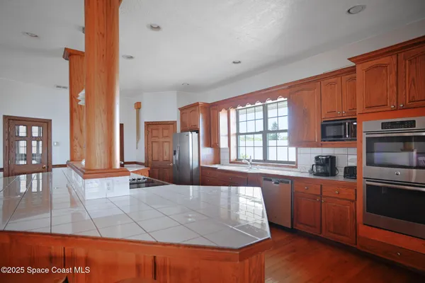 a kitchen with stainless steel appliances granite countertop a refrigerator and a stove