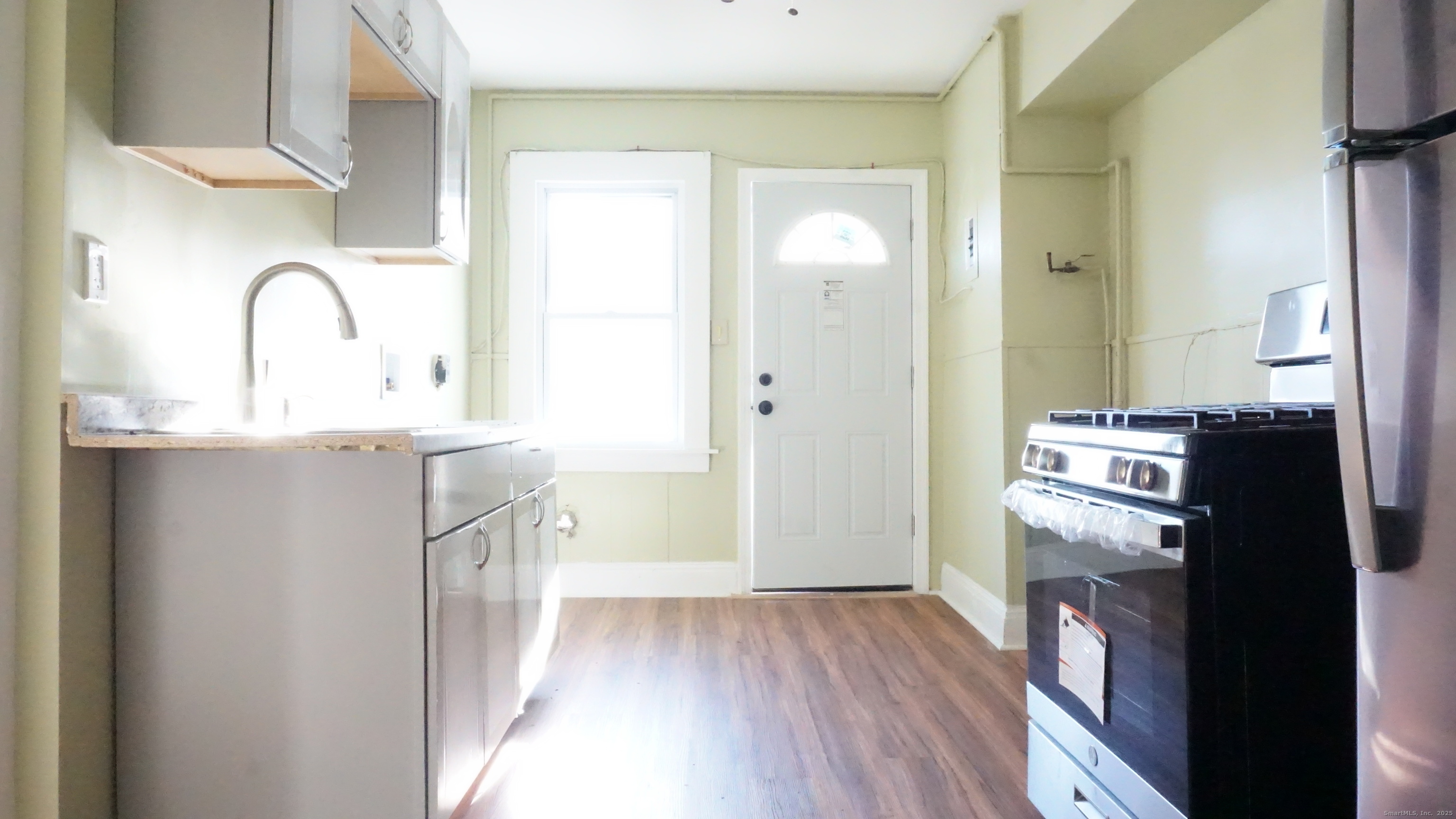 1621 Stratford Avenue, Unit 3 Stratford, CT 06615 - Photo 1 of 17 a kitchen with a refrigerator and a sink