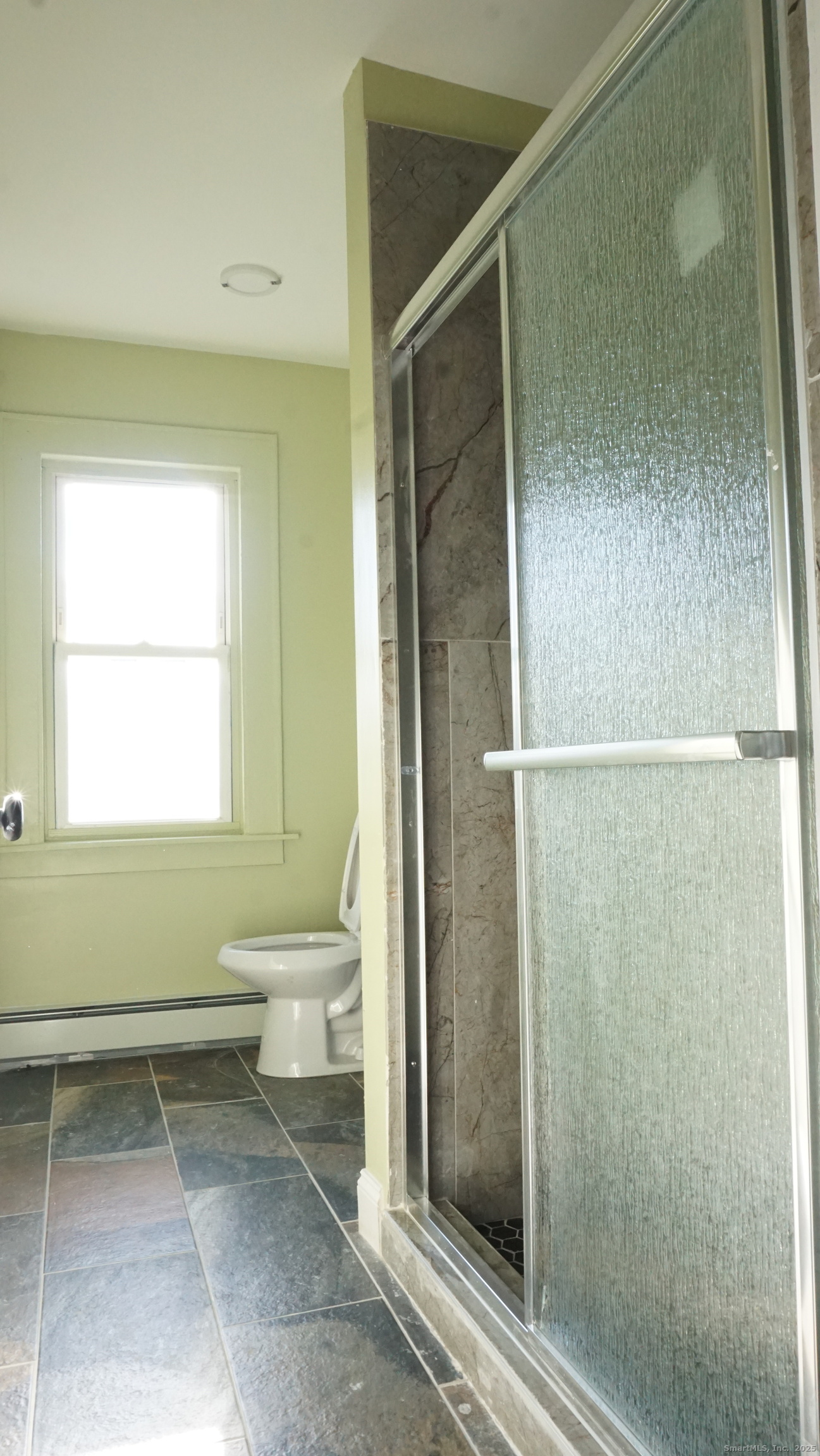 1621 Stratford Avenue, Unit 3 Stratford, CT 06615 - Photo 11 of 17 a bathroom with a bathtub and a shower